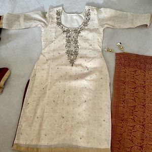 Cream, red, and gold salwar kameez